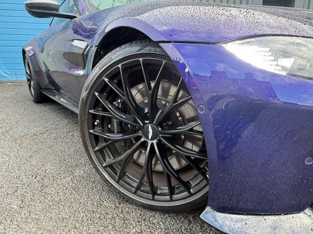 Close view of a purple sports car front wheel and bodywork outside JRM