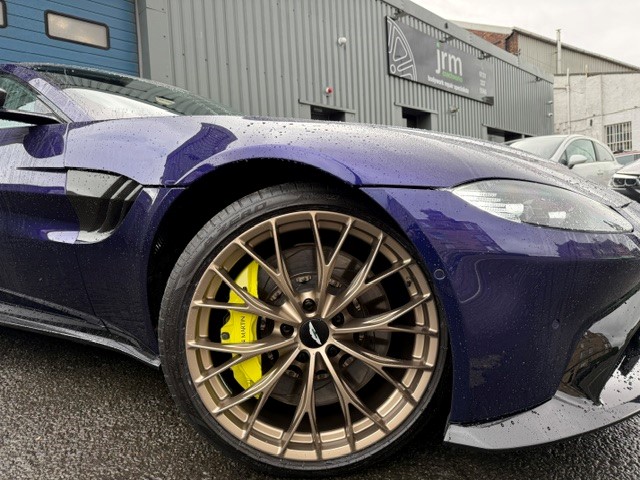 Purple sports car with gold wheel outside the JRM workshop