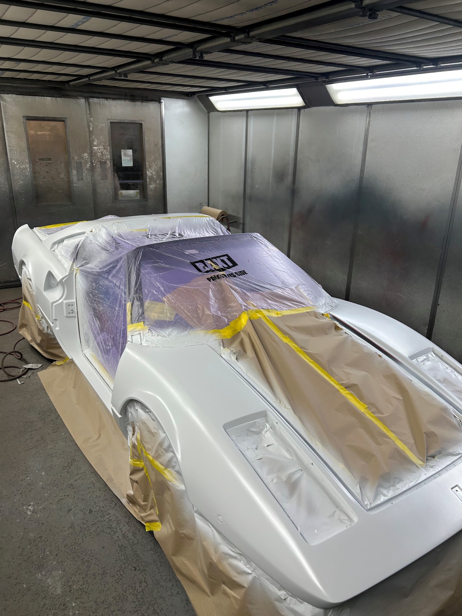 Vehicle masked for painting inside the JRM Coachworks spray booth